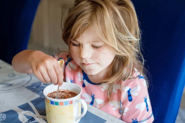 家庭用キッチンでホットチョコレートを飲む愛らしい女の子 幸せな就学前の子供 — ストック写真