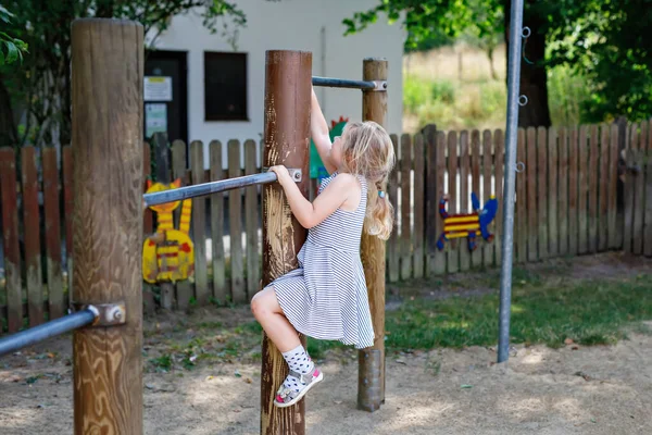 Little Preschool Girl Climbing Hanging Outdoor Horizontal Bar Cheerful Girl —  Fotos de Stock