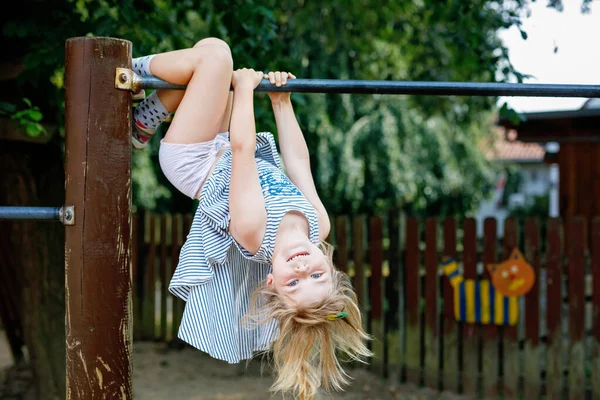 Little Preschool Girl Climbing Hanging Outdoor Horizontal Bar Cheerful Girl — Fotografia de Stock