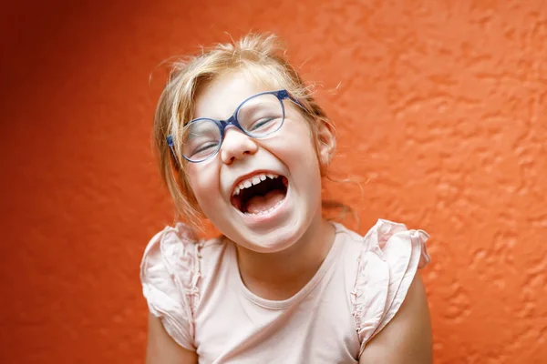 Happy Little Girl Glasses Orange Background Lauging Smiling Preschool Child — Zdjęcie stockowe
