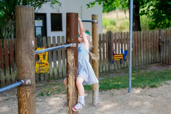 Little Preschool Girl Climbing Hanging Outdoor Horizontal Bar Cheerful Girl — Stockfoto