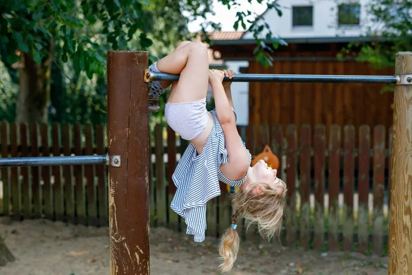 Little Preschool Girl Climbing Hanging Outdoor Horizontal Bar Cheerful Girl — Fotografia de Stock