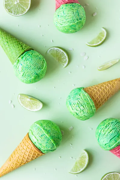 Homemade green ice cream with lime and mint in green waffle cone. Summer dessert. Top view. Selective focus.