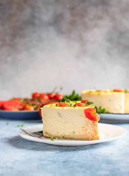 Piece of savoury tomato cheesecake with herbs decorated mint, blue concrete background. — Stock Photo, Image