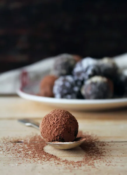 Homemade chocolate truffles with nuts, coconut and cocoa powder