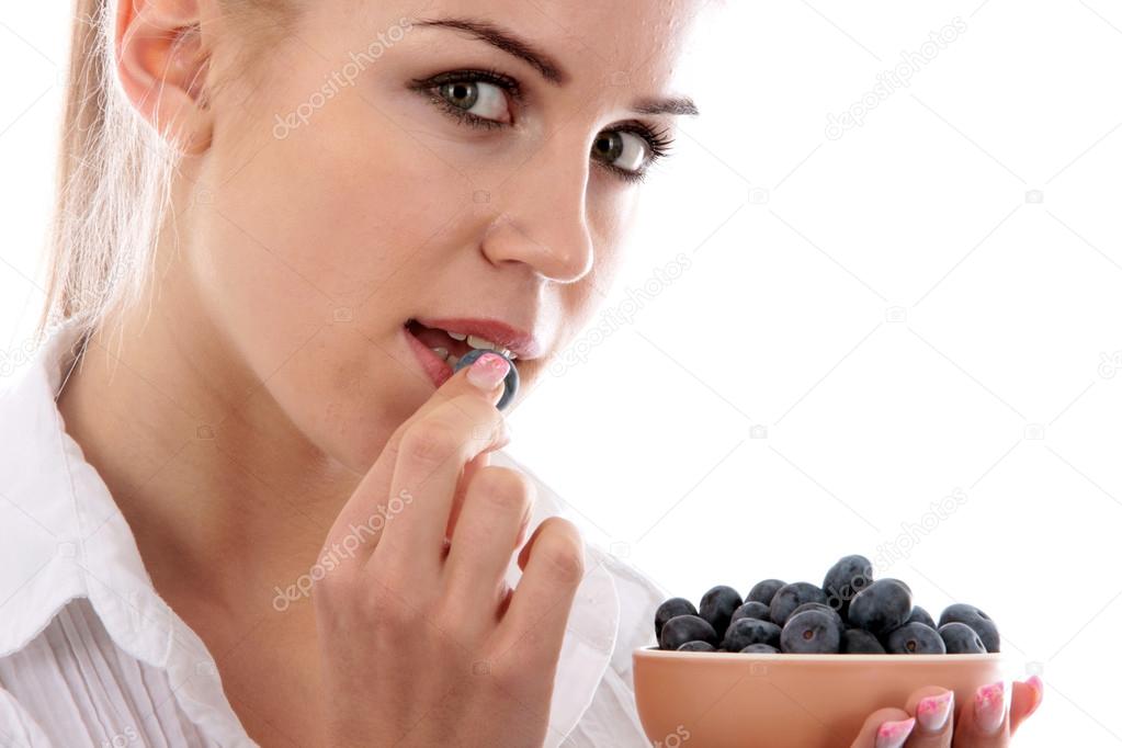 Young Woman Eating Blueberries