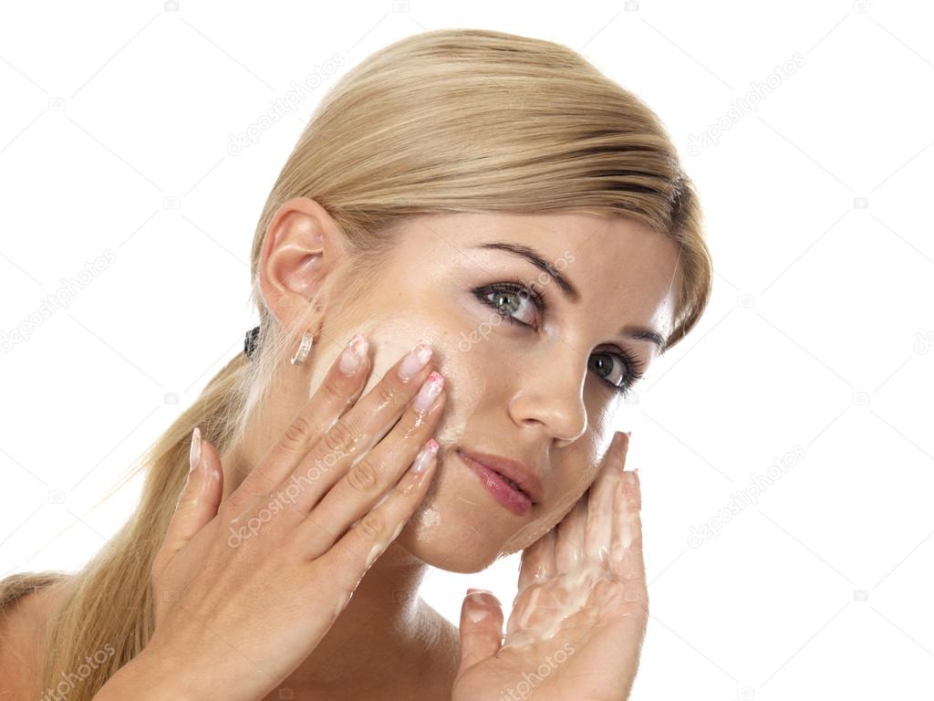 Young Woman Applying Face Cream Moisturiser