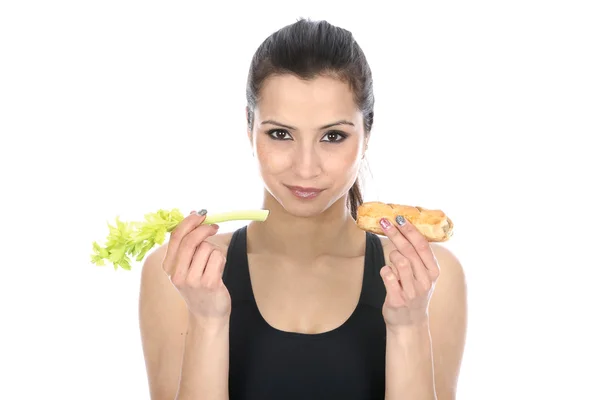 Woman Comparing Celery and a Sausage Roll — Stock Photo, Image