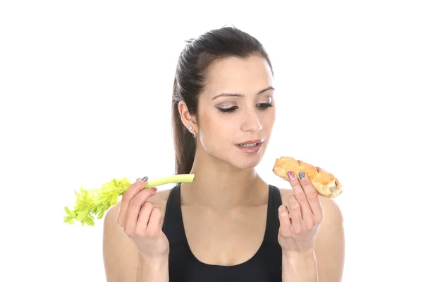 Woman Comparing Celery and a Sausage Roll — Stock Photo, Image