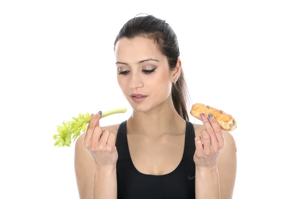 Woman Comparing Celery and a Sausage Roll — Stock Photo, Image