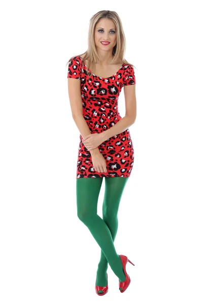 年轻女子身穿一件红色的迷你连衣裙及绿色紧身衣 — 图库照片
