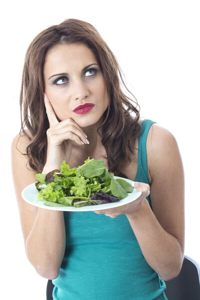 Attractive Young Woman Eating Green Leafed Salad