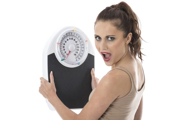 Attractive Shocked Young Woman Holding Bathroom Scales — Stock Photo, Image