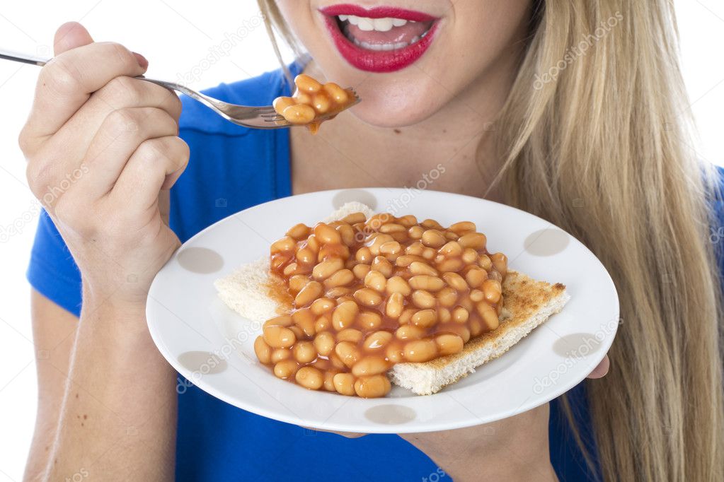 Young Woman Eating Baked Beans on Toast