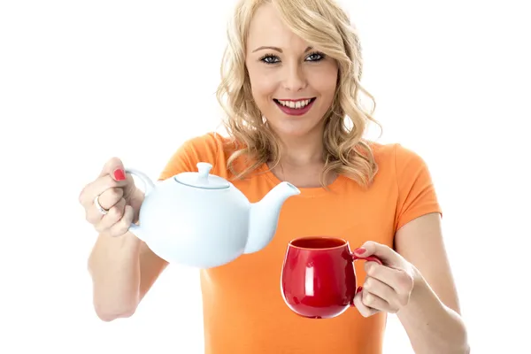 Attractive Young Woman Pouring Tea from a Teapot — Stock Photo, Image