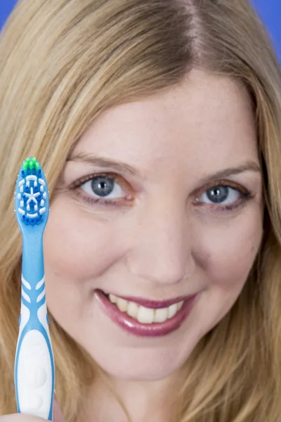 Happy Young Woman Holding a Toothbrush — Stock Photo, Image