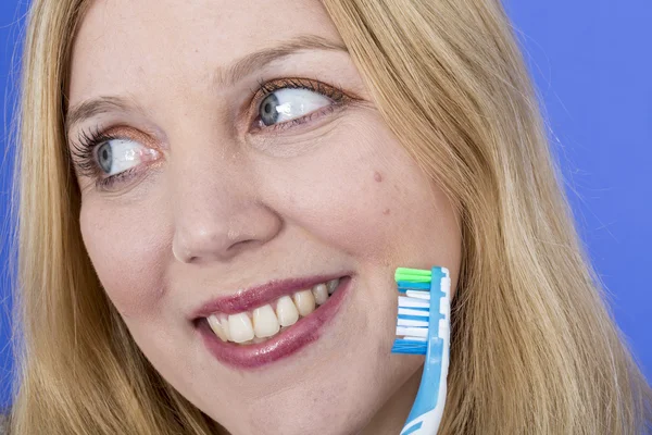 Happy Young Woman Holding a Toothbrush — Stock Photo, Image