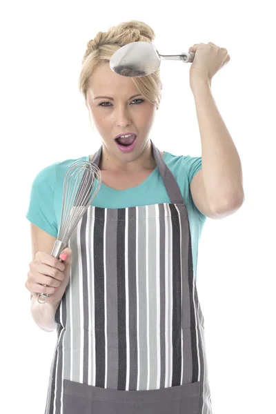 Angry Young Woman Holding Kitchen Utensils — Stock Photo, Image