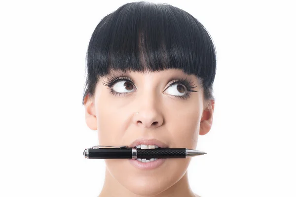 Junge Frau mit einem Stift im Mund — Stockfoto