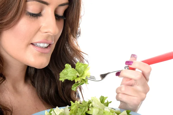 Jovem mulher comendo uma salada verde — Fotografia de Stock