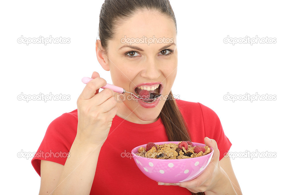 Happy Young Woman Eating Breakfast Cereal