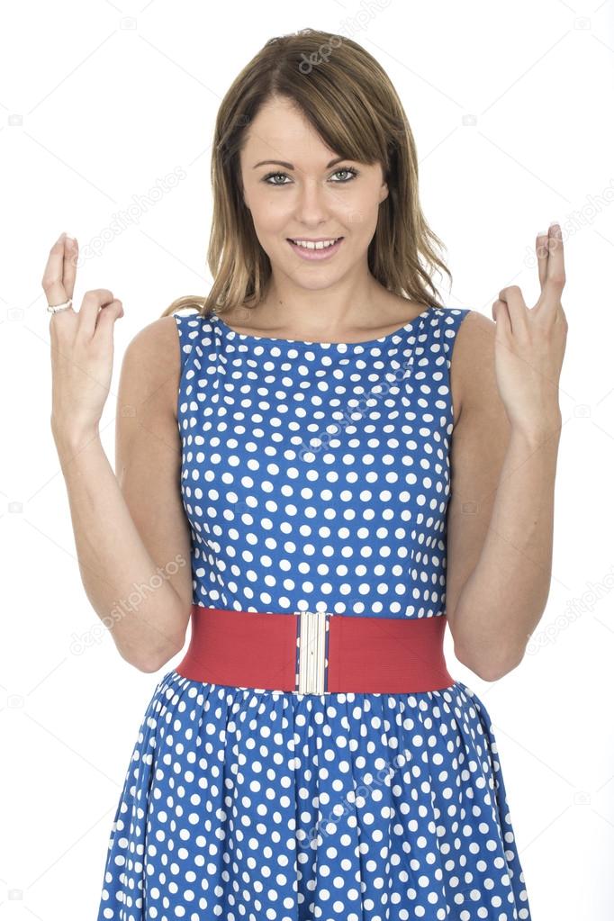 Young Woman Wearing Blue Polka Dot Dress Fingers Crossed