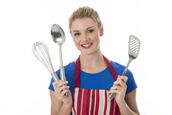Jovem mulher segurando utensílios de cozinha — Fotografia de Stock