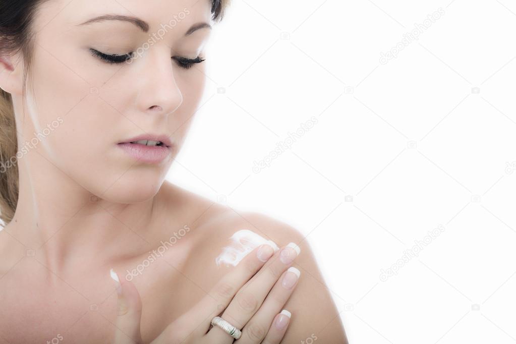 Attractive Young Woman Applying Moisturizing Cream