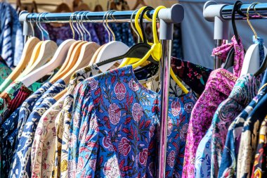 Dorking, Surrey Hills, London UK, July 07 2022, Colourful Indian Origin Clothes Hanging On Rails In An Open Market Traders Stall