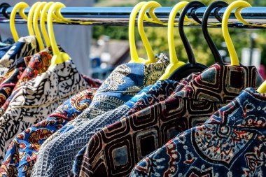Dorking, Surrey Hills, London UK, July 07 2022, Colourful Indian Origin Clothes Hanging On Rails In An Open Market Traders Stall