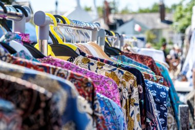 Dorking, Surrey Hills, London UK, July 07 2022, Bright Colourful Womens Dresses Hanging In Outdoor Market Stall With No People