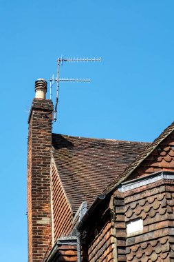 Dorking, Surrey Hills, London UK, July 07 2022, Traditional Brick And Tile Building Exterior Architecture With Classic Chimney And TV Aerial