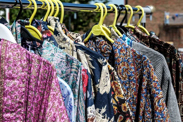 Dorking, Surrey Hills, London UK, July 07 2022, Bright Colourful Womens Dresses Hanging In Outdoor Market Stall With No People