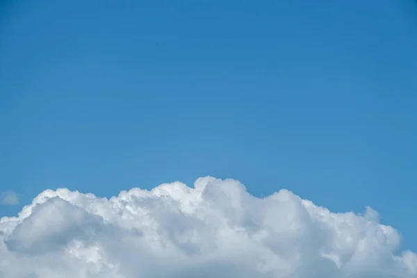 Dorking, Surrey Hills, London, UK, August 26 2022, Large White Cumulus Cloud Against A Clear Blue Sky With Copy Epace