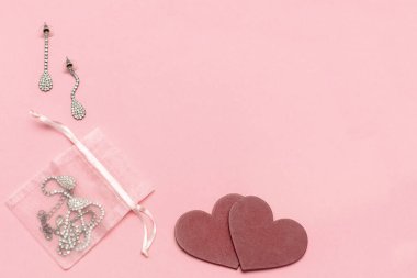 Jewelry earrings as gift on pink background copy space. Valentine's women Day, dating, love, birthday concept copy space.