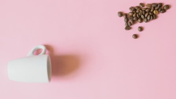 Stop motion creative video animation of coffee ceramic espresso cup, spoon and coffee beans with sugar stirring in mug on a pink background, morning waking up concept, mockup copy space — Stockvideo