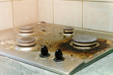 Kirli gaz sobasını yağdan temizlemek, yemek artıkları. Mutfak sobası. ev temizliği hizmeti kavramı.