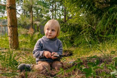 Çilek tohumu eken tatlı çocuk, organik bahçede toprak, orman. Tarım, tarım, ekoloji, çevre dostu, tarım, yaz konseptinde komik çocukluk..