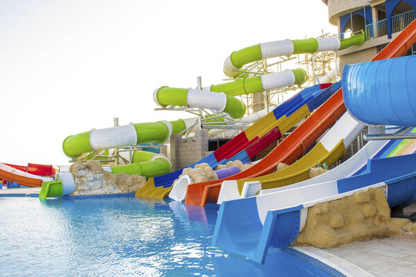 Aquapark slides in hotel complex, outdoor aqua, water park with swimming pool.extreme water slides during summer tropical vacation in Egypt, Africa.
