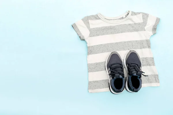 Summer babies gray clothes and accessories with t shirt,sneakers. Modern fashion kids casual outfit.Set of children's clothing for spring. Flat lay, top view,overhead,mockup.