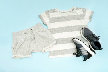 Summer babies gray clothes and accessories with t shirt, shorts,sneakers. Modern fashion kids casual outfit.Set of children's clothing for spring. Flat lay, top view,overhead,mockup