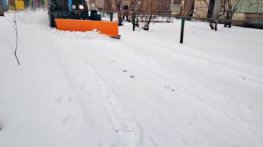 Snow remover truck, winter time tractor machine cleaning removing city streets from snow, after heavy blizzard, snowfall, cold bad weather conditions - Kiev, Ukraine,February 07 2022.