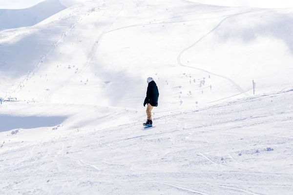 冬の全体で女の子 ヘルメット 雪の丘の上にスノーボードに乗ってメガネ ヨーロッパの高山スキーリゾートでの斜面 冬の休日 屋外自然景観 カルパティア山脈 ウクライナ — ストック写真