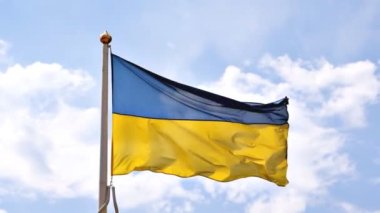 Ukrainian national blue and yellow colors flag waving in the wind against blue sky.Ukraine National government patriotic symbol,Independence,Constitution day.