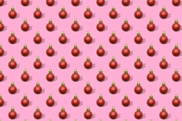 クリスマスの年末年始は 赤いボール 装飾品 フラットレイ トップビューと創造的な最小限のシームレスなパターンピンクの背景 — ストック写真