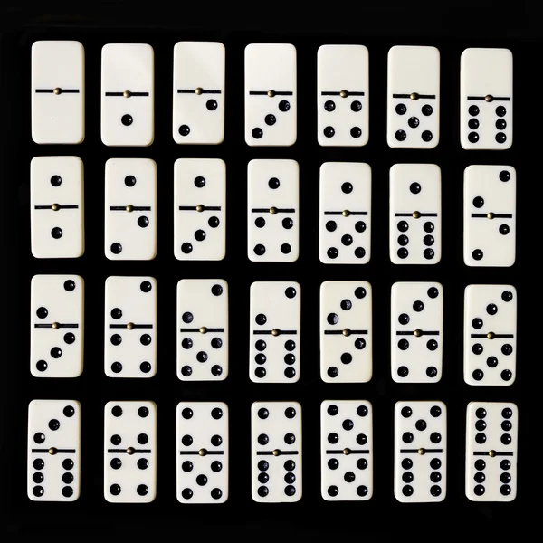 Dominosteine isoliert auf schwarzem Hintergrund — Stockfoto
