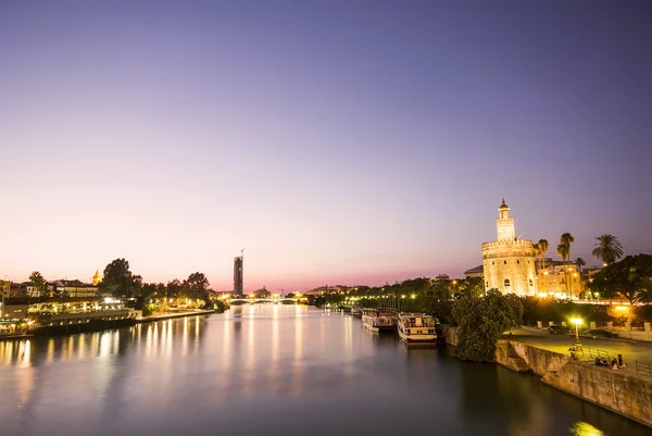 View at sunset of the Guadalquivir River and the Torre del Oro, Royalty Free Stock Photos