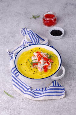 Sarı püre, yengeç eti ve kırmızı havyar. Taş zemin. Seçici odak.