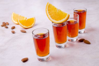 Açık arkaplandaki bardakta şeffaf kahverengi sıvı. Seçici odak.