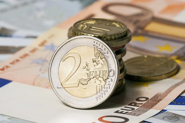 Some banknotes on five and fifty euros and coins — Stock Photo, Image